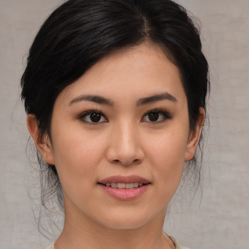 Joyful asian young-adult female with medium  brown hair and brown eyes