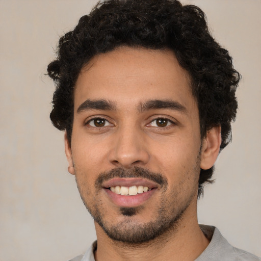 Joyful white young-adult male with short  black hair and brown eyes