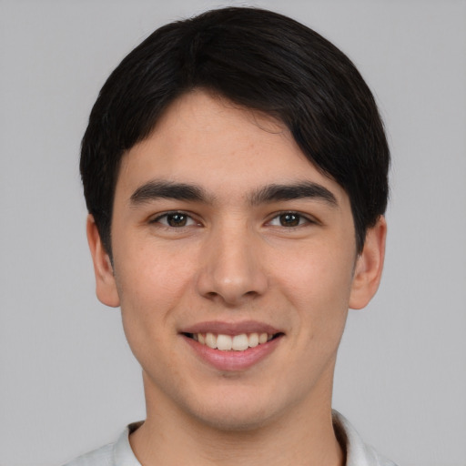 Joyful asian young-adult male with short  black hair and brown eyes