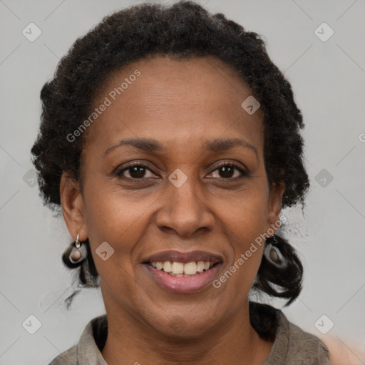 Joyful black adult female with short  brown hair and brown eyes