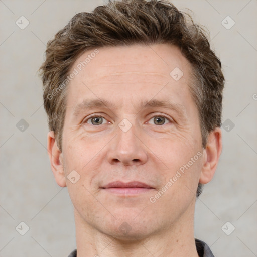 Joyful white adult male with short  brown hair and grey eyes