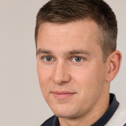 Joyful white adult male with short  brown hair and brown eyes