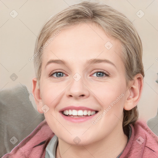 Joyful white young-adult female with medium  brown hair and blue eyes