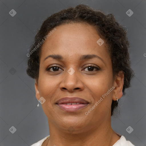 Joyful black adult female with short  brown hair and brown eyes