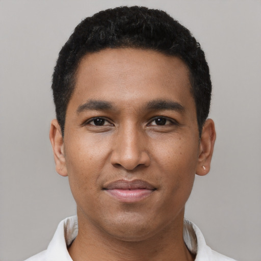 Joyful black young-adult male with short  black hair and brown eyes