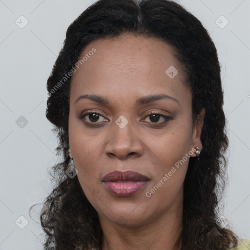 Joyful black adult female with long  brown hair and brown eyes