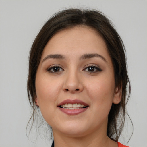 Joyful white young-adult female with medium  brown hair and brown eyes