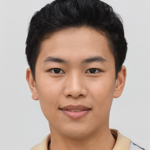 Joyful asian young-adult male with short  brown hair and brown eyes