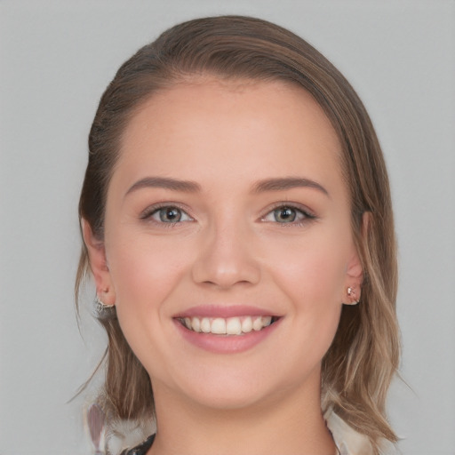 Joyful white young-adult female with long  brown hair and blue eyes