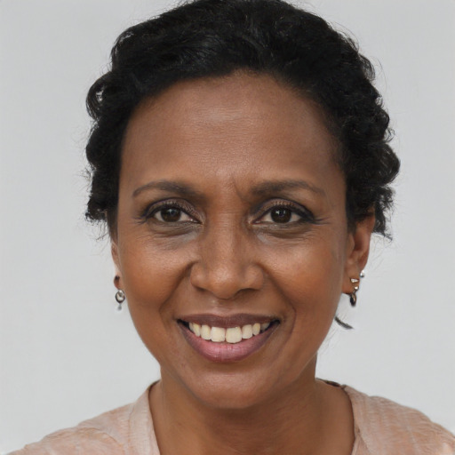 Joyful black adult female with short  brown hair and brown eyes