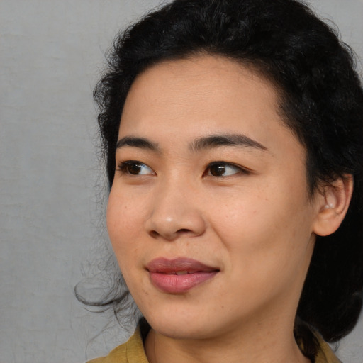 Joyful asian young-adult female with long  black hair and brown eyes