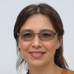 Joyful white adult female with medium  brown hair and brown eyes