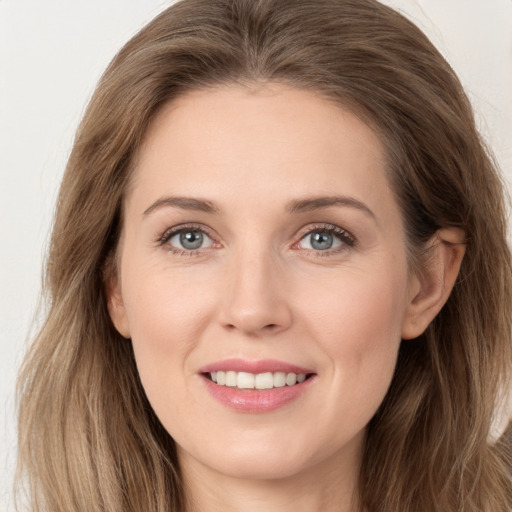 Joyful white young-adult female with long  brown hair and grey eyes