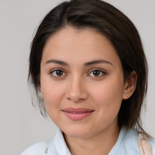 Joyful white young-adult female with medium  brown hair and brown eyes