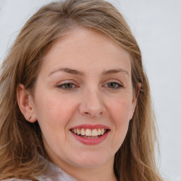 Joyful white young-adult female with long  brown hair and blue eyes