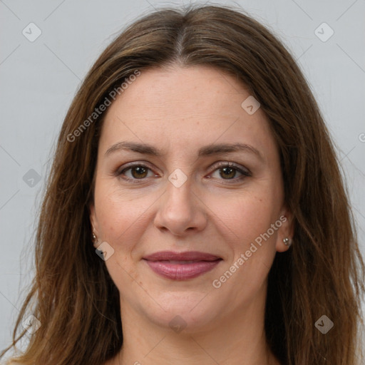 Joyful white adult female with long  brown hair and brown eyes