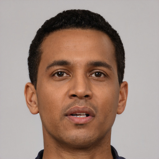 Neutral black young-adult male with short  black hair and brown eyes