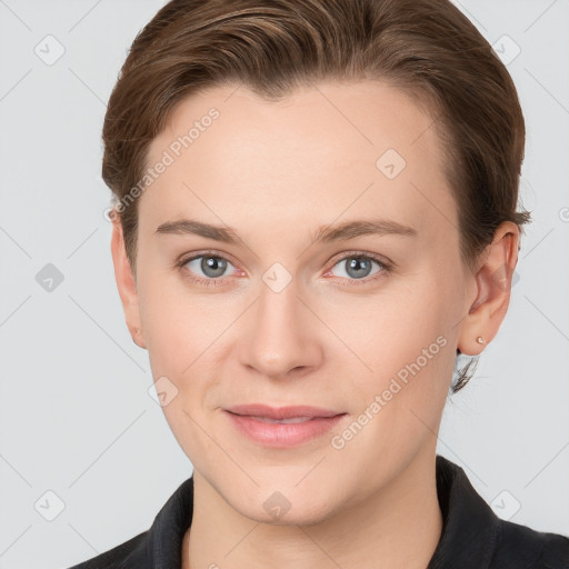 Joyful white young-adult female with short  brown hair and grey eyes