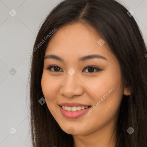 Joyful latino young-adult female with long  brown hair and brown eyes