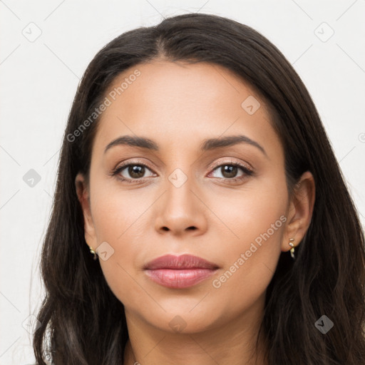 Joyful latino young-adult female with long  brown hair and brown eyes