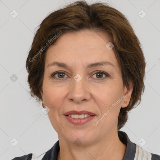 Joyful white adult female with medium  brown hair and grey eyes