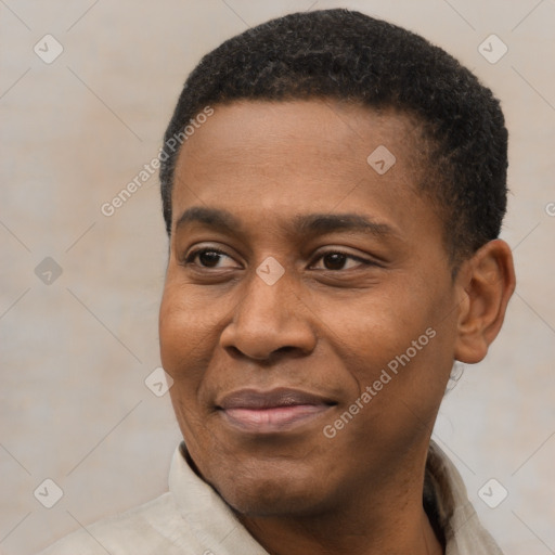 Joyful black young-adult male with short  black hair and brown eyes