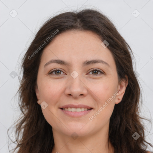 Joyful white adult female with long  brown hair and brown eyes