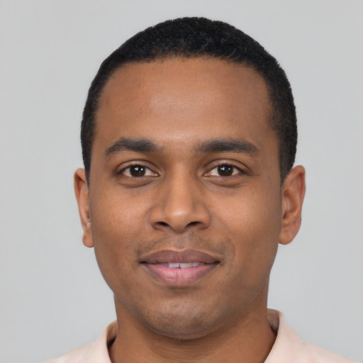 Joyful black young-adult male with short  black hair and brown eyes