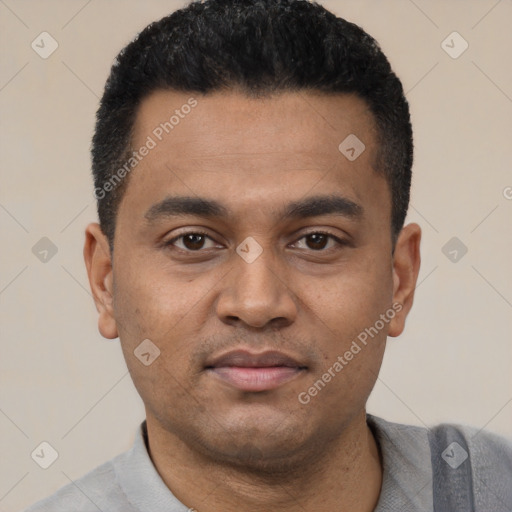 Joyful latino young-adult male with short  black hair and brown eyes