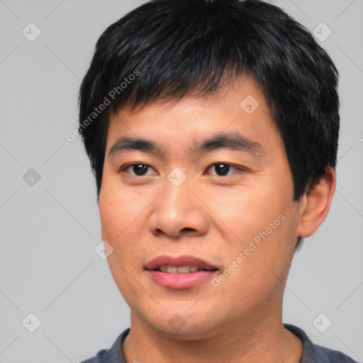 Joyful asian young-adult male with short  black hair and brown eyes