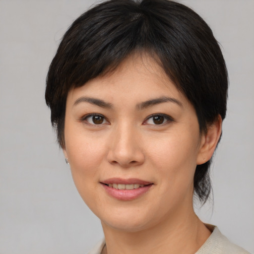 Joyful asian young-adult female with medium  brown hair and brown eyes