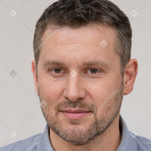 Joyful white adult male with short  brown hair and brown eyes