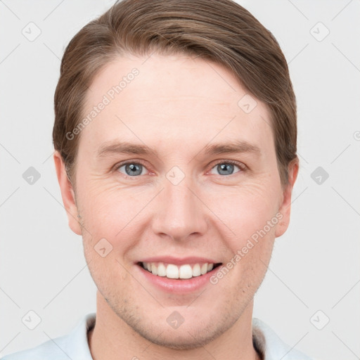 Joyful white young-adult male with short  brown hair and grey eyes