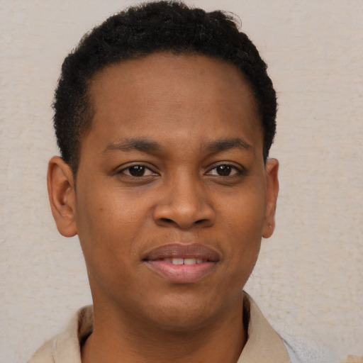 Joyful black young-adult male with short  brown hair and brown eyes