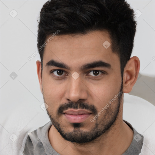 Neutral latino young-adult male with short  black hair and brown eyes