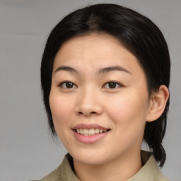 Joyful asian young-adult female with medium  brown hair and brown eyes