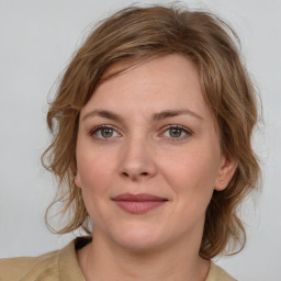 Joyful white young-adult female with medium  brown hair and green eyes