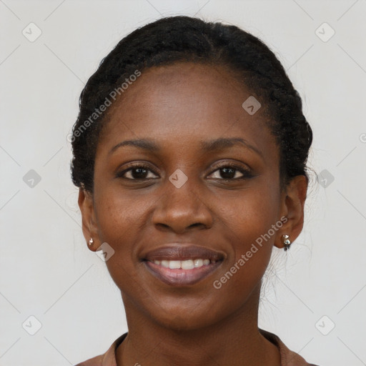 Joyful black young-adult female with long  black hair and brown eyes