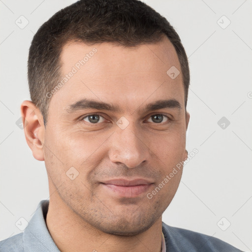 Joyful white young-adult male with short  brown hair and brown eyes