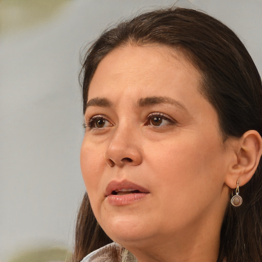 Joyful white adult female with long  brown hair and brown eyes