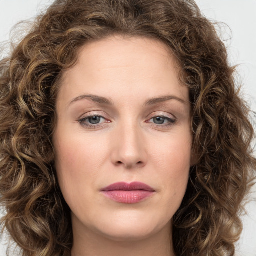 Joyful white young-adult female with long  brown hair and green eyes