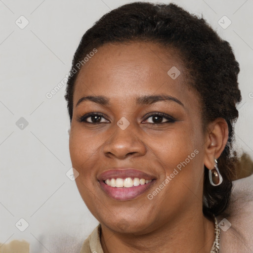 Joyful black young-adult female with short  brown hair and brown eyes