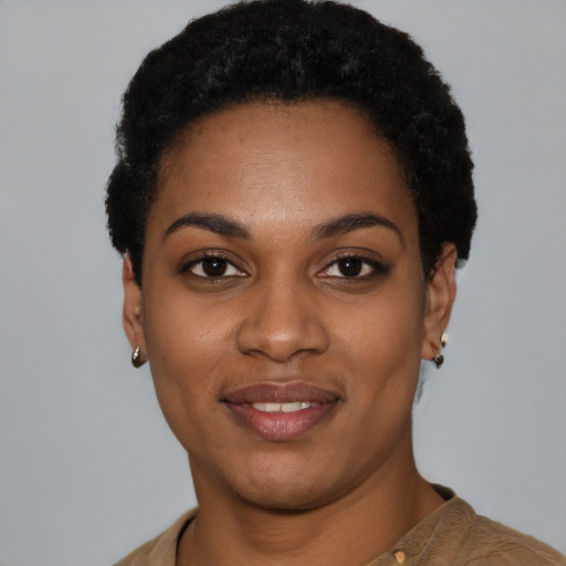 Joyful black young-adult female with short  black hair and brown eyes