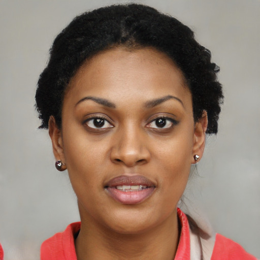 Joyful black young-adult female with short  brown hair and brown eyes