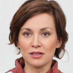 Joyful white young-adult female with medium  brown hair and blue eyes
