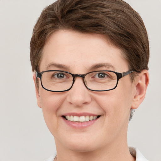 Joyful white young-adult female with short  brown hair and grey eyes