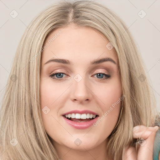 Joyful white young-adult female with long  brown hair and green eyes