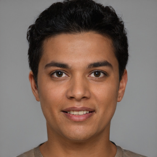 Joyful latino young-adult male with short  brown hair and brown eyes