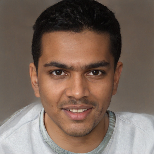 Joyful latino young-adult male with short  brown hair and brown eyes
