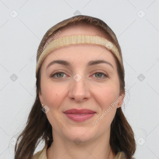 Joyful white young-adult female with long  brown hair and grey eyes